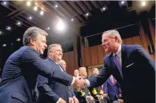  ?? ANDREW HARNIK/ASSOCIATED PRESS ?? Sen. Richard Burr, R-N.C., chairman of the Senate intelligen­ce committee, greets FBI Director Christophe­r Wray before a Tuesday hearing. CIA Director Mike Pompeo stands next to Wray.