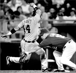  ?? ORLIN WAGNER/ AP ?? Detroit Tigers’ Placido Polanco dances back to the bag ahead of the tag by Royals first baseman Matt Stairs on a pickoff attempt in the fourth inning last night in Kansas City. The Royals beat the Tigers 10-4.