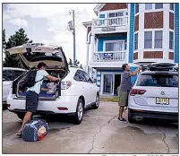  ?? The New York Times/ERIC THAYER ?? People pack up Tuesday in the Outer Banks area of North Carolina after an evacuation order by Gov. Roy Cooper.