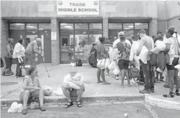  ?? ANDREW CABALLERO-REYNOLDS/AFP/GETTY IMAGES ?? People line up to enter a hurricane shelter at Trask Middle School in North Carolina on Tuesday. More than a million people have fled their homes.