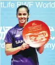  ??  ?? Saina Nehwal of India celebrates during the awards ceremony after beating Akane Yamaguchi of Japan to win the women’s singles title at the Badminton China Open in Fuzhou, China’s Fujian province on November 16, 2014. - AFP photo