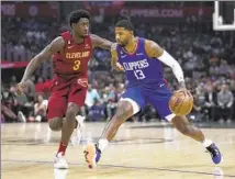  ?? Ashley Landis Associated Press ?? THE CLIPPERS’ Paul George, who finished with 26 points, controls the ball against Cleveland Cavaliers guard Caris LeVert.