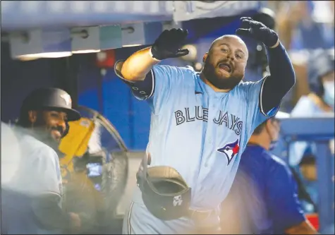  ?? NATHAN RAY SEEBECK/USA TODAY SPORTS ?? Blue Jays designated hitter Rowdy Tellez celebrates in the dugout after hitting his first home run of the season Tuesday night — although his teammates took their time to join in the party.