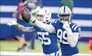  ?? MICHAEL CONROY/AP ?? DeForest Buckner (99) celebrates after recovering a fumble in OT that set up the Colts’ game-winning field goal Sunday. The Colts gave up a late field goal in regulation but went on to beat the visiting Packers 34-31.