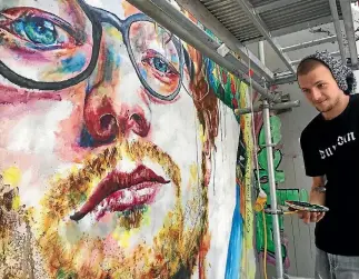  ?? PHOTO: HAMISH MCNEILLY/STUFF ?? Artist Tyler Kennedy Stent working on his Ed Sheeran mural in Dunedin.