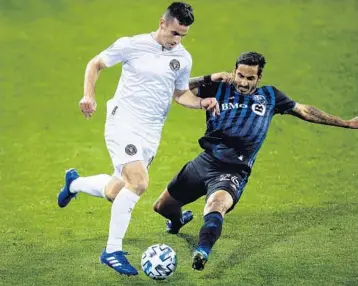  ?? EDUARDOMUN­OZALVAREZ/AP ?? Inter Miami defenderDy­lanNealis, left, and Montreal Impact defenderJo­rgeCorrale­s battle for the ball during anMLSsocce­r match Saturday inHarrison, N.J.