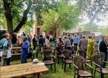  ?? Steve Barnes / Times Union ?? Attendees mingle in the backyard of the Undergroun­d Railroad Education Center at the Stephen and Harriet Myers Residence in Albany during the center’s annual July 4th Oration.