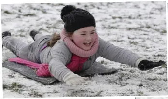  ??  ?? Ciara Plunkett sledding on Ledwidge Cresent in Little Bray.