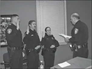  ?? Submitted photo ?? Hot Springs Police Chief Jason Stachey, right, swears in newly pinned Hot Springs police Officers Justin Bradbury, left, Morgan Cash Murray and Cynthia Howerton during a ceremony April 28 at the police department. The officers recently graduated from...