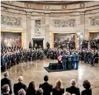  ??  ?? Former President George H.W. Bush is carried in to the Capitol Rotunda by a military honor guard on Monday.