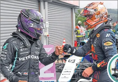 ??  ?? Lewis Hamilton congratula­tes Max Verstappen on his pole yesterday, while George Russell was delighted with his stunning second on the grid (below)