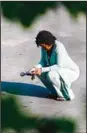  ?? (AP) ?? A person pauses outside the scene of a shooting at a supermarke­t, in Buffalo, NY, May 15.