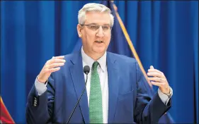  ?? MICHAEL CONROY/AP ?? Gov. Eric Holcomb, pictured March 24, says he’s waiting on the Indiana Election Commission to provide recommenda­tions on election safety.