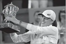  ?? CHRISTOPHE ENA/AP PHOTO ?? Iga Swiatek presents the cup after defeating Coco Gauff in the women final match of the French Open on Sunday in Paris.