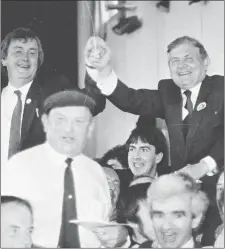  ?? Photo by Michelle Cooper Galvin ?? John O’Donoghue celebrates with Fianna Fáil colleague John O’Leary after their election to the Dáil in 1987 with (in foreground) Jackie Healy Rae, Fianna Fáil’s then Director of Elections in Kerry.