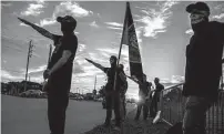  ?? Meridith Kohut/ Staff photograph­er ?? Members of the Aryan Freedom Network perform the Nazi salute during a gathering in Katy last year. Hate groups such as this one have become emboldened.