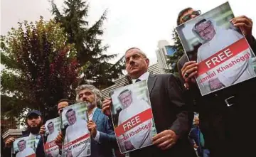  ?? PIC REUTERS ?? Human rights activists and friends of Saudi journalist Jamal Khashoggi holding his pictures during a protest outside the Saudi Consulate in Istanbul, Turkey last week.