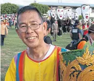  ??  ?? Loei governor Chaiwat Chuenkosum holds an elaborate ghost mask at the festival. He also joins in the fun as the event got off to a full swing.