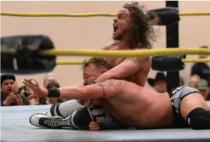  ?? Associated Press ?? ■ Bayou Independen­t wrestler Barrett Brown holds Frankie Thomas in a chokehold March 7 during a wrestling event at the West Monroe Civic Center in West Monroe, La.