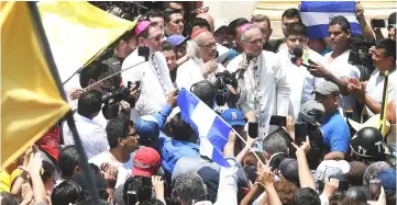  ??  ?? Baez speaks next to Cardinal Leopoldo Jose Brenes (centre) and Papal Nuncio Stanislaw Waldemar Sommertag (left) upon arrival in Masaya, Nicaragua. — AFP photo