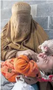  ??  ?? A healthcare worker administer­s a polio vaccine to a child at a clinic in Peshawar, Pakistan.