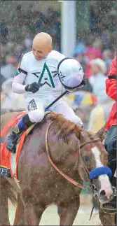  ?? BARBARA D. LIVINGSTON JIM LEUENBERGE­R ?? Justify and Mike Smith win the Kentucky Derby in the slop at Churchill Downs. For Justify, the win came in only his fourth start. He won a maiden race Feb. 18 at Santa Anita in his debut, followed by an allowance race and the Santa Anita Derby.