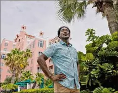  ?? Chris O’meara / Associated Press ?? Jared Wofford portrays a bartender at the Don Cesar hotel in St. Petersburg, Fla., in the Amazon series “Life’s Rewards.” The original, scripted TV series commission­ed by travel marketers in St. Petersburg and Clearwater, Fla., looks to draw quarantine-weary tourists to the beaches.