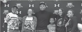  ?? ?? John Bush, Jaleesa Green, Kingston Jackson, Janae Green and Jada Green join Kendall Jackson after Kendall signed his letter of intent for Texas A&M at Buchholz High School in Gainesvill­e on Tuesday.