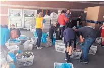  ?? COURTESY OF ROADRUNNER FOOD BANK ?? Volunteers sort through U.S. Postal Service bins of food from the Saturday Stamp Out Hunger food drive, which collected 175,600 pounds of food in Albuquerqu­e and Rio Rancho.