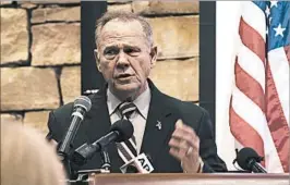  ?? WES FRAZER/GETTY ?? GOP Senate candidate Roy Moore calls the allegation­s false Saturday in Vestavia Hills, Ala.