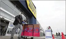  ?? MARK MORAN/THE CITIZENS’ VOICE VIA AP ?? Shoppers leave a Best Buy store on Black Friday, in Wilkes-Barre, Pa., Nov. 27, 2020.