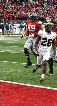  ??  ?? Ohio State’s Curtis Samuel jumps for joy and into the end zone in the second overtime to clinch the win against Michigan at Ohio Stadium on Saturday.