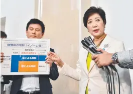  ?? OVERDUE: Tokyo governor Yuriko Koike ( right) speaks to reporters after passing the new anti- smoking rules ahead of the 2020 Olympics. Picture: AFP ??