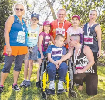  ??  ?? Melinda Donnelly (front right) and her son Talon, 9, with their support group for the 2km race.