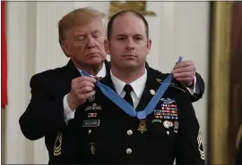  ?? ALEX BRANDON — THE ASSOCIATED PRESS ?? President Donald Trump places the Medal of Honor on Army Master Sgt. Matthew Williams during a ceremony in the the White House on Wednesday.