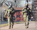  ?? Christian Abraham / Hearst Connecticu­t Media ?? Members of the State Police Emergency Services Unit patrol the Capitol grounds ahead of planned protests in Hartford on Sunday.