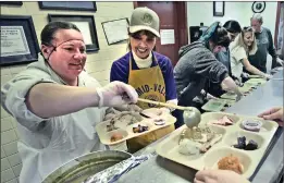  ?? Dan Watson/The Signal ?? Volunteers Tatiana Heuilar, left, and Janey Wratten prepare plates to be served to attendees for the 2018 Thanksgivi­ng Feast at the SCV Senior Center on Thursday.