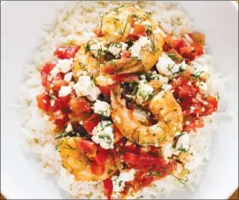  ?? The Associated Press ?? This recipe for Greek-Style shrimp with tomatoes and feta appears in the cookbook Complete Mediterran­ean.