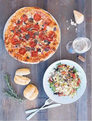  ?? COURTESY OF SAUCE PIZZA & WINE ?? Sauce Pizza & Wine has chosen Albuquerqu­e for its first expansion outside of its home state of Arizona. Pictured is the Suprema pizza and vegetable salad.