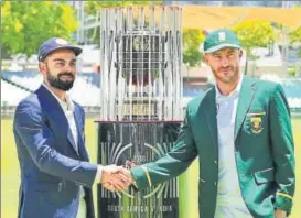  ?? BCCI ?? ▪ Skippers Virat Kohli and Faf du Plessis unveil the Freedom Series trophy in Cape Town.