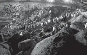  ?? AP/KHALIL HAMRA ?? Muslim pilgrims visit the holy mountain of Jabal Al Rahma, or mountain of forgivenes­s, as they arrive Wednesday at Arafat, Saudi Arabia, outside the holy city of Mecca.