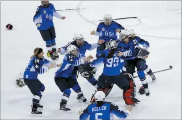  ?? MATT SLOCUM — THE ASSOCIATED PRESS ?? United States celebrates winning the gold medal hockey game against Canada at the 2018 Winter Olympics in Gangneung, South Korea, Thursday.