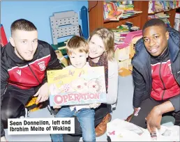  ??  ?? Sean Donnellan, left and Ibrahim Meite of Woking