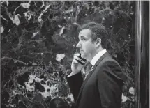  ?? SAM HODGSON / THE NEW YORK TIMES ?? Michael Cohen, President Donald Trump’s longtime personal lawyer, walks through the lobby of Trump Tower in New York. The FBI raided Cohen’s office on Monday, seizing records involving Trump.