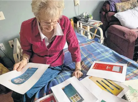  ?? TIDEVIEW TERRACE FACEBOOK PAGE ?? A Tideview Terrace resident looks through the selection of real door decals available to install in the seniors long-term care home.