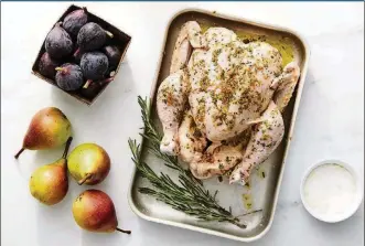  ?? FOOD STYLED BY SIMON ANDREWS / PHOTOS BY RYAN LIEBE/THE NEW YORK TIMES ?? A chicken with figs and pears is prepared for roasting. Roasted figs and pears lend a gentle sweetness to roast chicken.