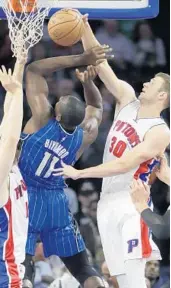  ?? CARLOS OSORIO/ASSOCIATED PRESS ?? Detroit forward Jon Leuer swats the ball away from Orlando big man Bismack Biyombo in the first half on Friday.