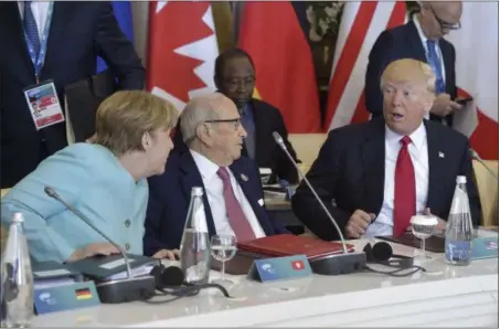  ?? FLAVIO LO SCALZO — ANSA VIA AP ?? US President Donald Trump shares a word with German Chancellor Angela Merkel, left, as Tunisia’s President Beji Caid Essebsi listens, at a G7 Summit expanded session, in the Sicilian town of Taormina, Italy, Saturday.