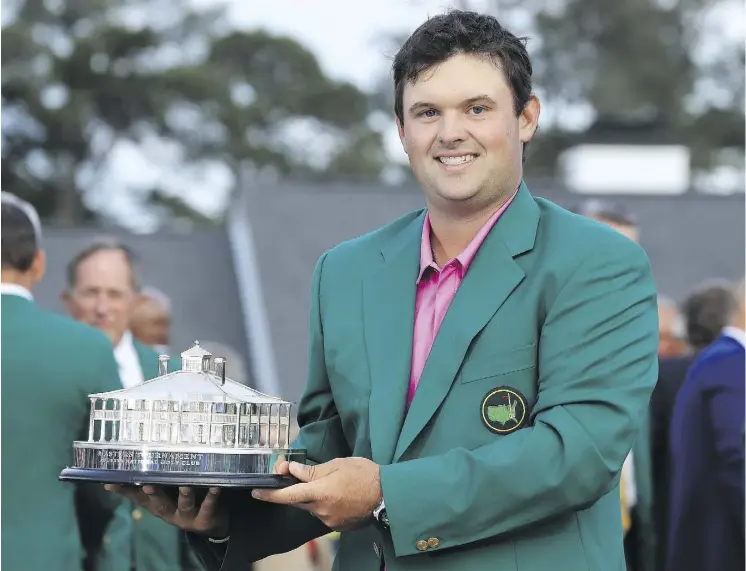  ?? DAVID CANNON/GETTY IMAGES ?? Patrick Reed celebrates with his trophy during the green jacket ceremony after winning the 2018 Masters by one stroke on Sunday in Augusta, Ga.