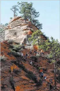  ?? BRETT LE BLANC/ LAS VEGAS REVIEe-JOURNAL ?? Hikers scramble toward the peak of Angels Landing during the last half-mile stretch of the strenuous trail in Utah’s Zion National Park.